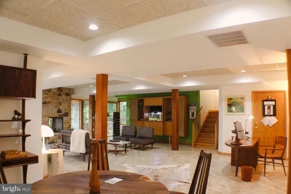 an aerial view of residential house with outdoor space and trees all around