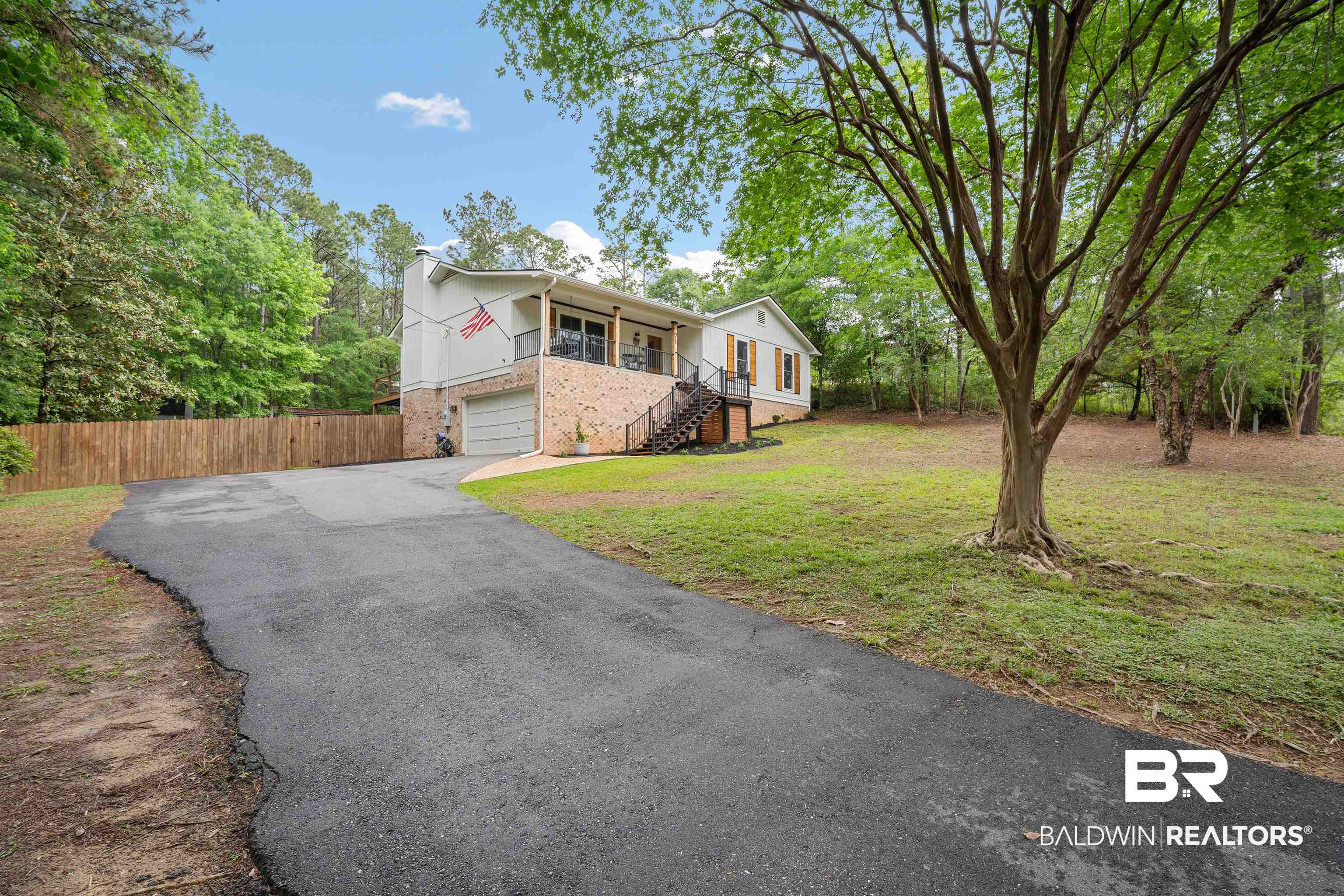 71 Caisson Trace Daphne, AL 36527 - Photo 2 of 36 Split-level residence featuring a brick and siding facade with a covered upper-level porch