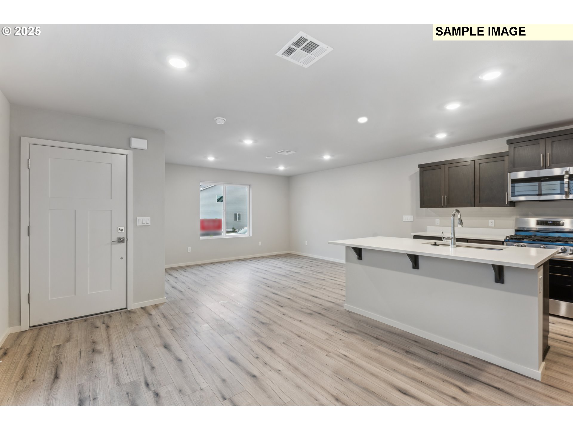 736 Merriott Lane Woodburn, OR 97071 - Photo 12 of 35 a view of kitchen with stainless steel appliances refrigerator stove microwave and cabinets