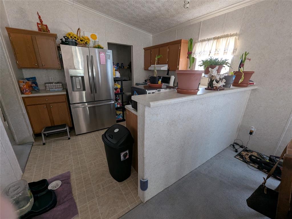 5139 Northeast Sandy Road Arcadia, FL 34266 - Photo 23 of 45 a kitchen with refrigerator a washer and dryer