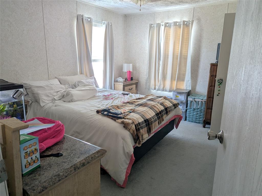 5139 Northeast Sandy Road Arcadia, FL 34266 - Photo 24 of 45 a bedroom with a bed and window