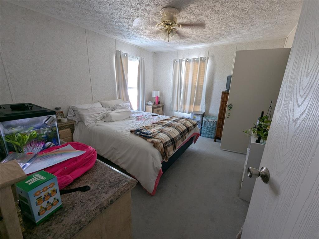 5139 Northeast Sandy Road Arcadia, FL 34266 - Photo 26 of 45 a bedroom with a bed dresser and a window