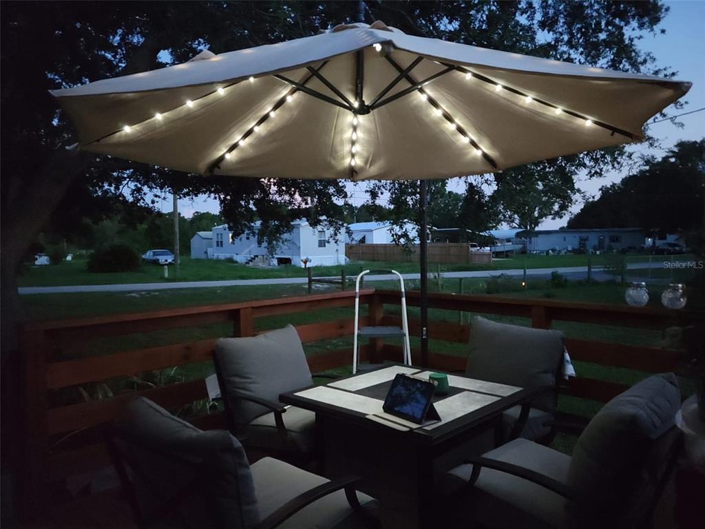 5139 Northeast Sandy Road Arcadia, FL 34266 - Photo 40 of 45 a table and chairs in the patio next to a yard