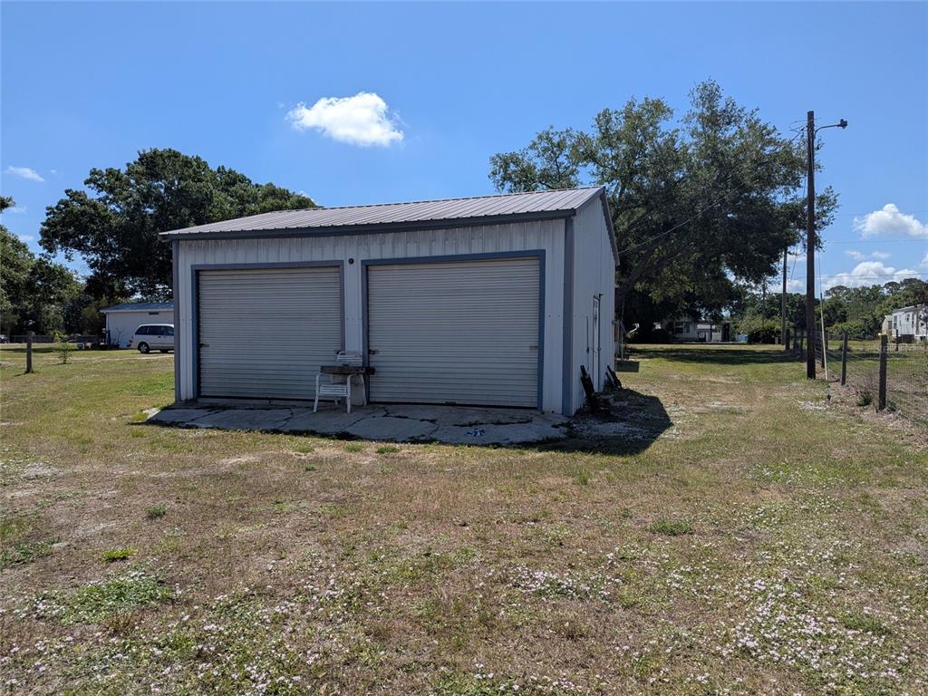 5139 Northeast Sandy Road Arcadia, FL 34266 - Photo 45 of 45 a view of a house with a yard and garage