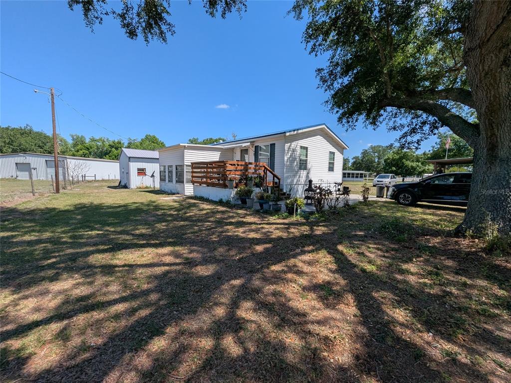5139 Northeast Sandy Road Arcadia, FL 34266 - Photo 5 of 45 a view of a house with a yard