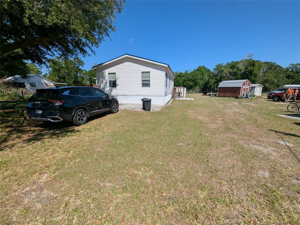 5139 Northeast Sandy Road Arcadia, FL 34266 - Photo 6 of 45 a view of a house with a yard and parking space