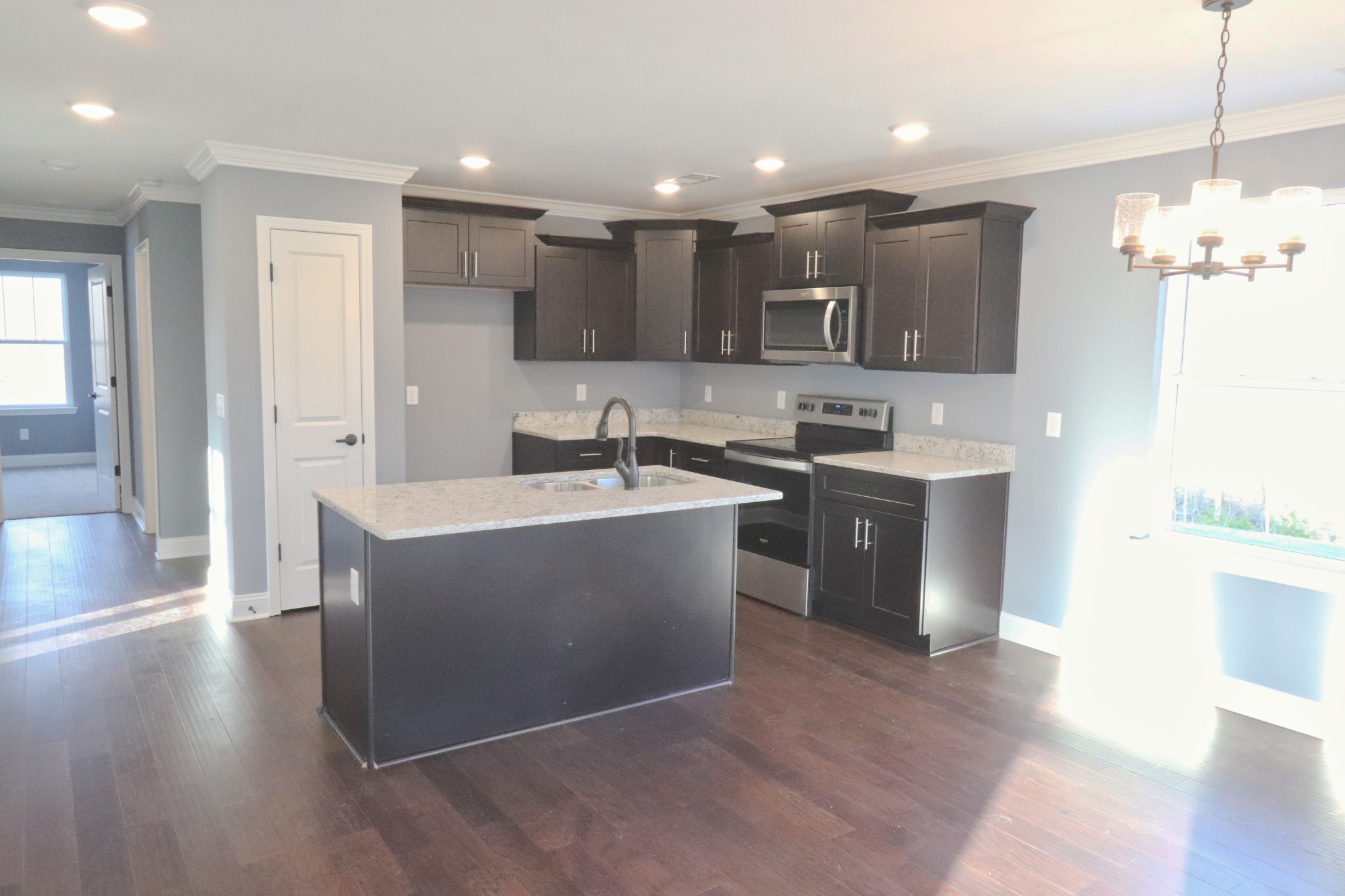 250 Still Point Road Smithville, TN 37166 - Photo 7 of 30 a kitchen with kitchen island a sink stainless steel appliances and cabinets