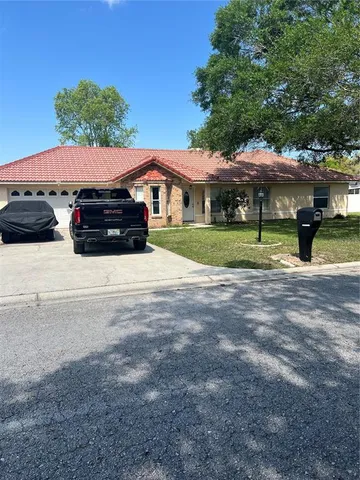 a view of a house with a yard and sitting area