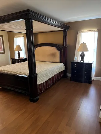 a spacious bedroom with a bed and window