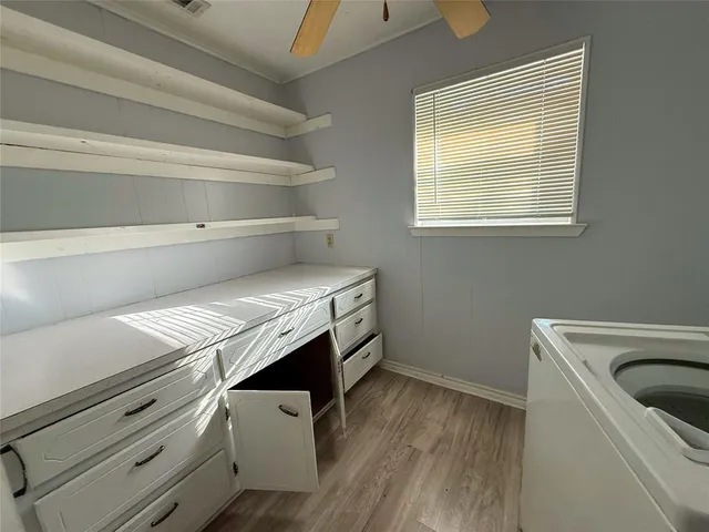 a view of empty room with window and ceiling fan