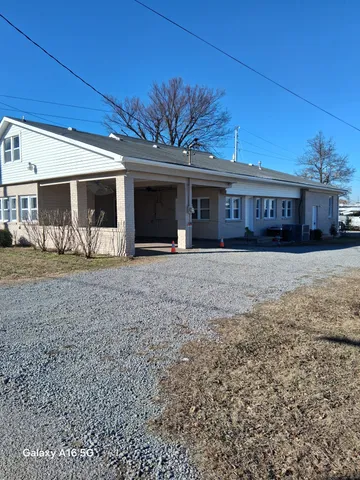 a view of a house with a backyard