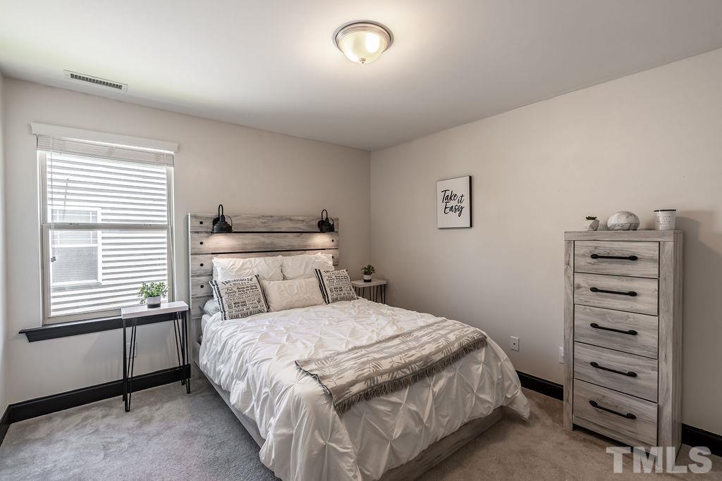 3578 Eastern Branch Road Raleigh, NC 27610 - Photo 17 of 24 a bedroom with a bed and a walk in closet
