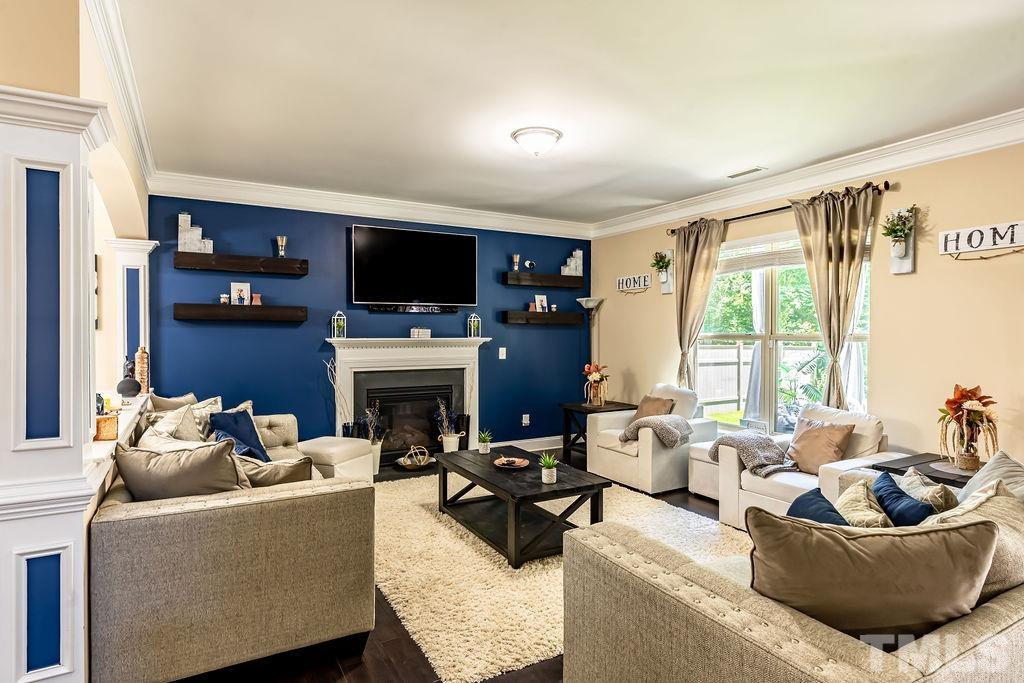 3578 Eastern Branch Road Raleigh, NC 27610 - Photo 4 of 24 a living room with furniture a fireplace and a flat screen tv