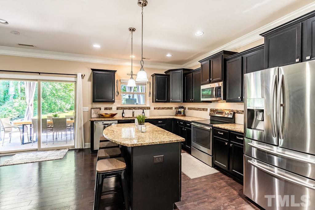 3578 Eastern Branch Road Raleigh, NC 27610 - Photo 6 of 24 a kitchen with stainless steel appliances granite countertop a sink refrigerator and cabinets