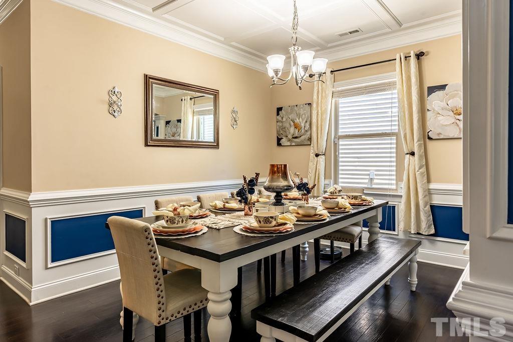3578 Eastern Branch Road Raleigh, NC 27610 - Photo 9 of 24 a view of a dining room with furniture a chandelier and wooden floor