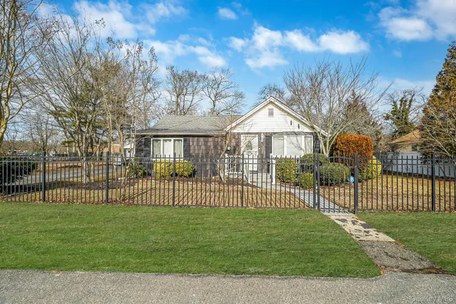 a view of a house with a fence and a garden