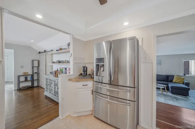 a kitchen with stainless steel appliances a refrigerator and a stove top oven