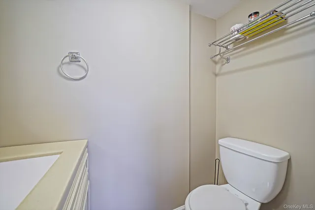 a white toilet sitting next to a shower