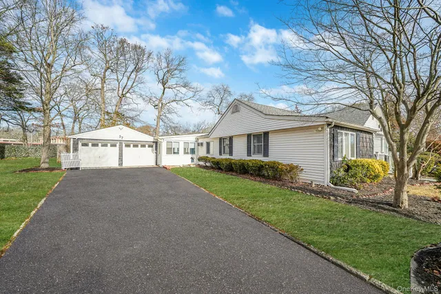 a view of house that has a yard