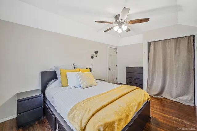 a bedroom with a bed and ceiling fan