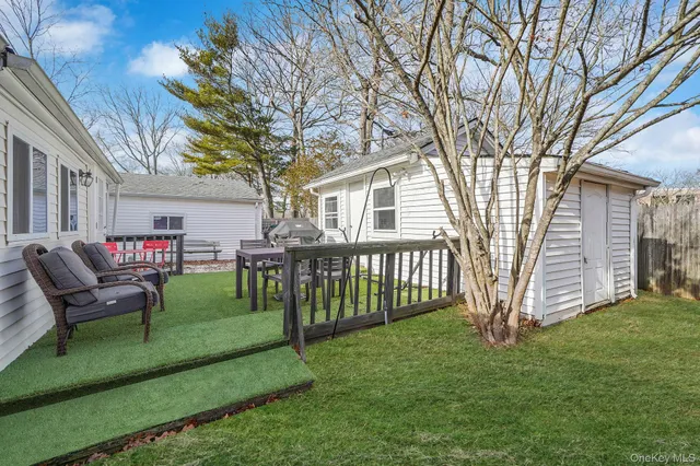 a front view of a house with a garden and deck
