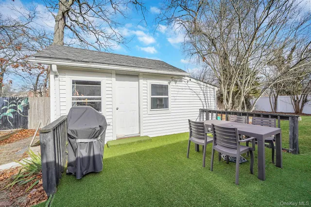 a view of a backyard with table and chairs