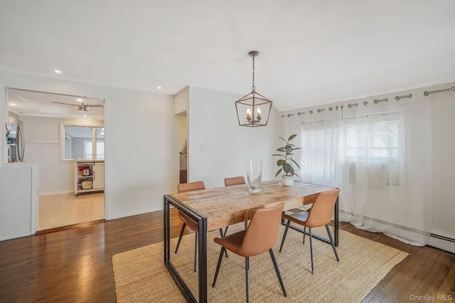 a view of a dining room with furniture wooden floor and a chandelier