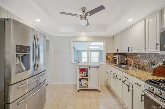 a kitchen with stainless steel appliances granite countertop a sink and a stove