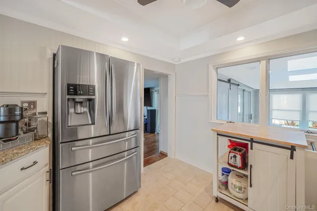 a kitchen with stainless steel appliances granite countertop a refrigerator and a sink