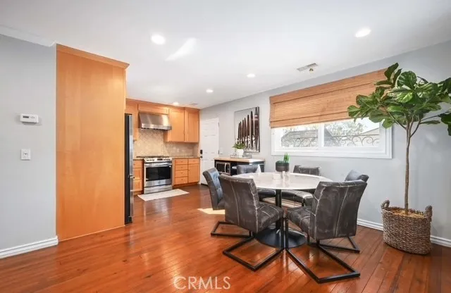 a view of a dining room with furniture window and wooden floor