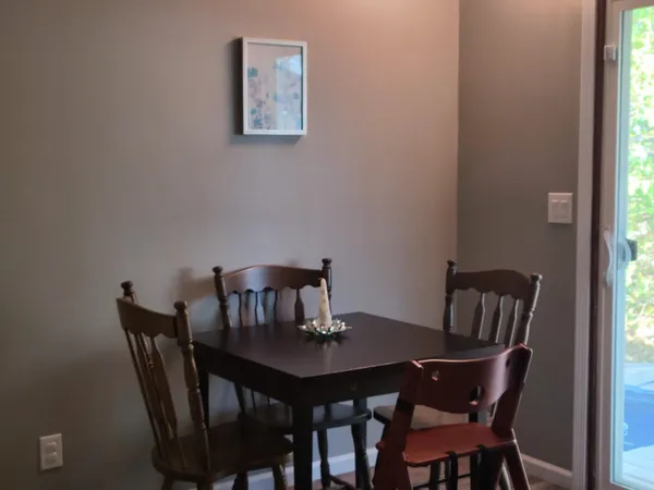a view of a dining room with furniture and window
