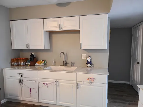 a kitchen with cabinets appliances a sink and a window