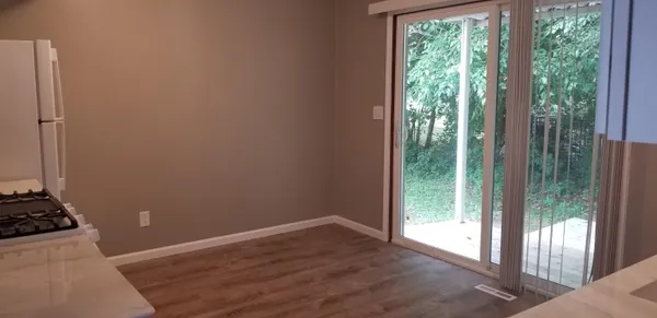 a view of a room with wooden floor and a window
