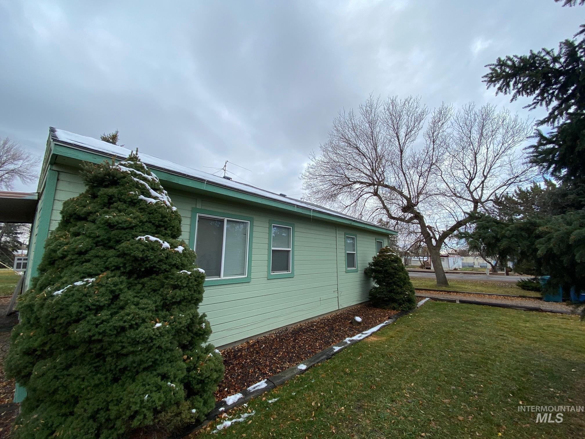 View of side of home featuring a yard