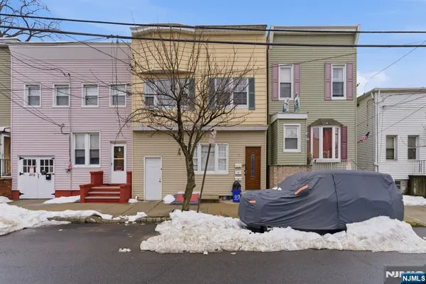 a front view of a building with parking space