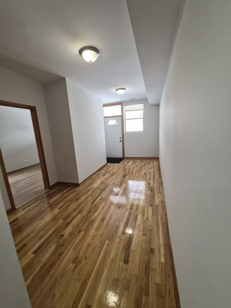 4828 South Indiana Avenue, Unit 201 Chicago, IL 60615 - Photo 14 of 17 a view of a big room with wooden floor and windows