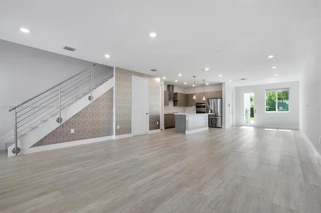 a view of kitchen with refrigerator and window