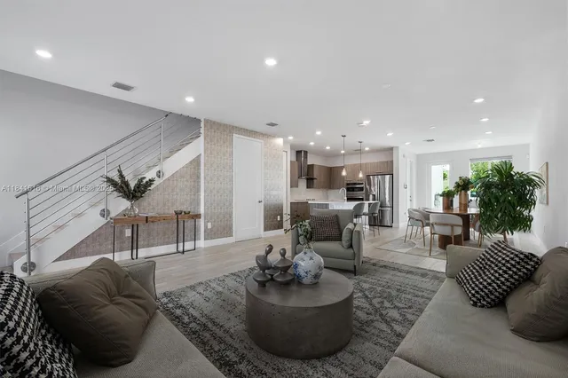 a living room with furniture and a potted plant