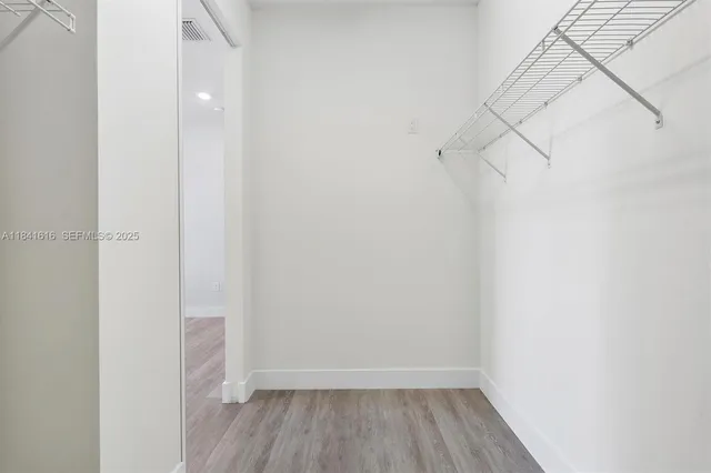 a view of a room with wooden floor