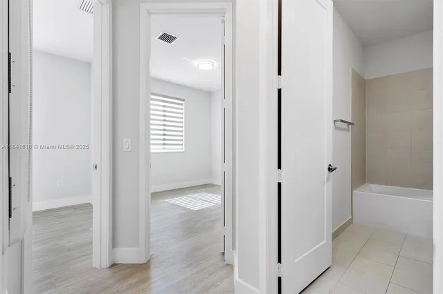 a view of a bathroom from a hallway