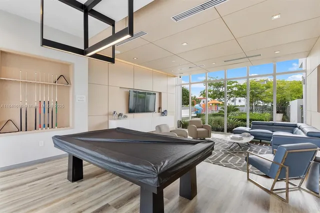 a view of a patio with couches and table and chairs with wooden floor and fence