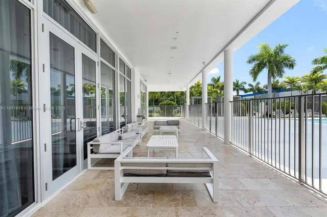 a view of a patio with a table and chairs under an umbrella