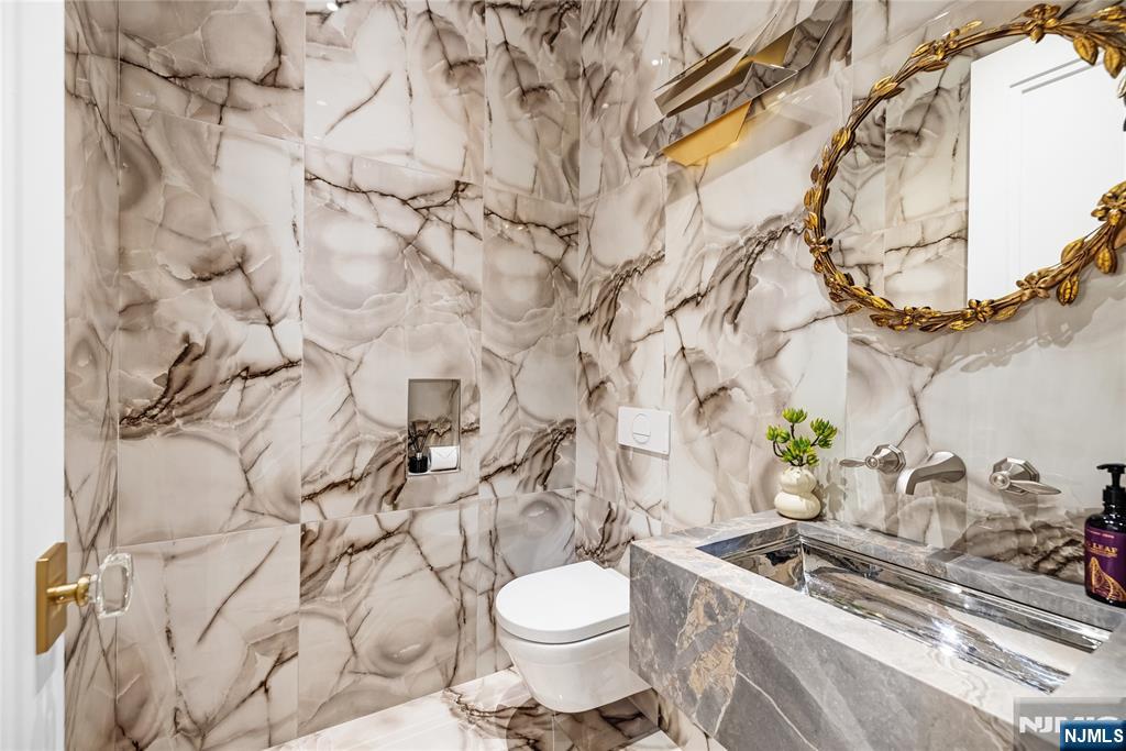 241 East Saddle River Road Saddle River, NJ 07458 - Photo 12 of 48 a bathroom with a granite countertop toilet and sink
