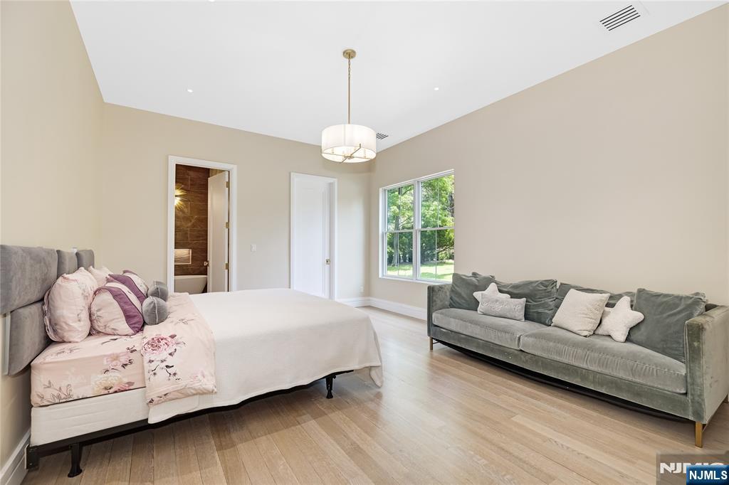 241 East Saddle River Road Saddle River, NJ 07458 - Photo 16 of 48 a bedroom with a bed and a couch