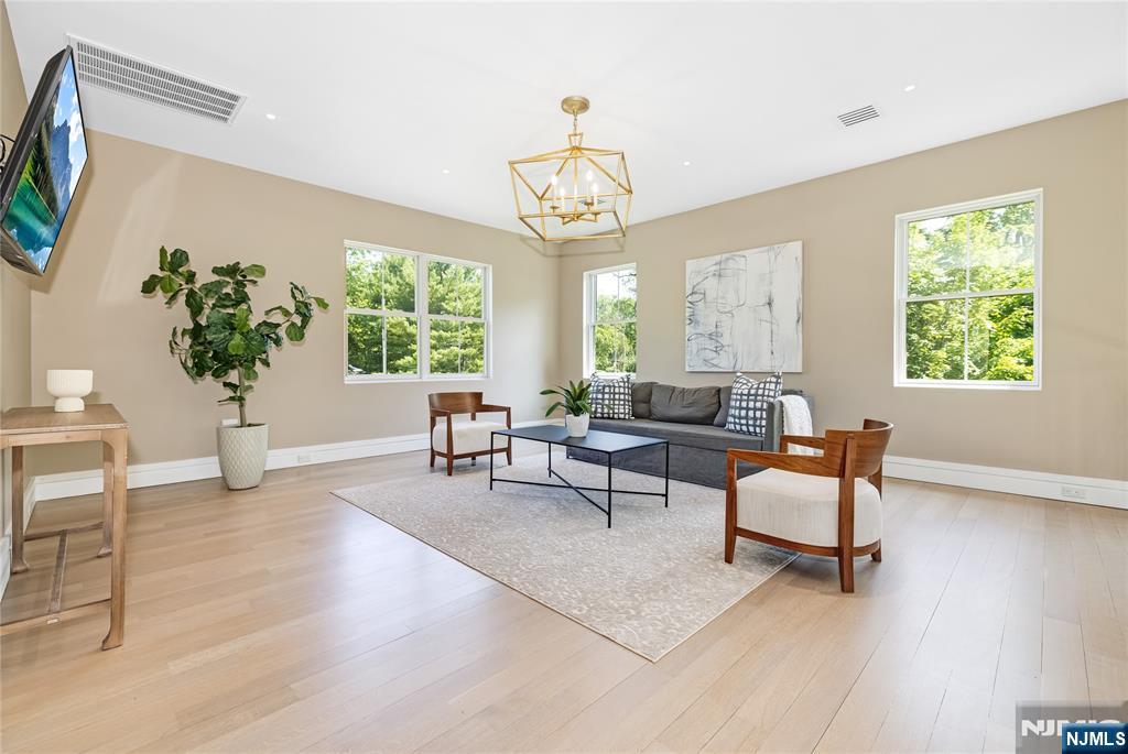 241 East Saddle River Road Saddle River, NJ 07458 - Photo 18 of 48 a living room with furniture a window and a chandelier