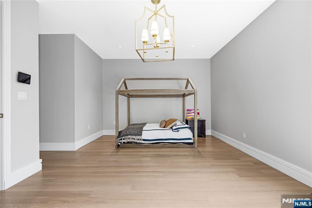 241 East Saddle River Road Saddle River, NJ 07458 - Photo 24 of 48 a room with wooden floor and white cabinet