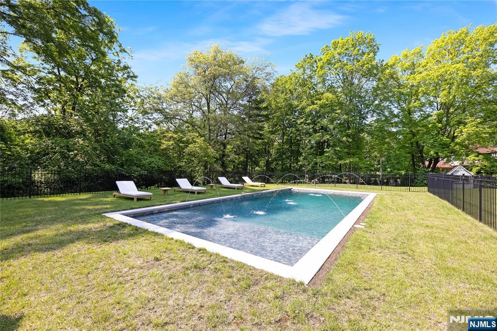 241 East Saddle River Road Saddle River, NJ 07458 - Photo 43 of 48 a view of a swimming pool with a yard