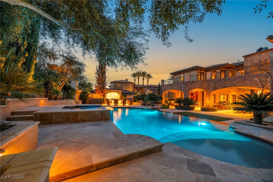1793 Anelli Court Henderson, NV 89012 - Photo 12 of 47 Pool at dusk featuring a pool with connected hot tub and a patio area
