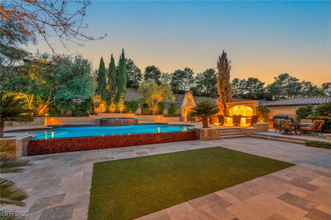 1793 Anelli Court Henderson, NV 89012 - Photo 13 of 47 View of pool featuring a patio area, a yard, and a pool with connected hot tub