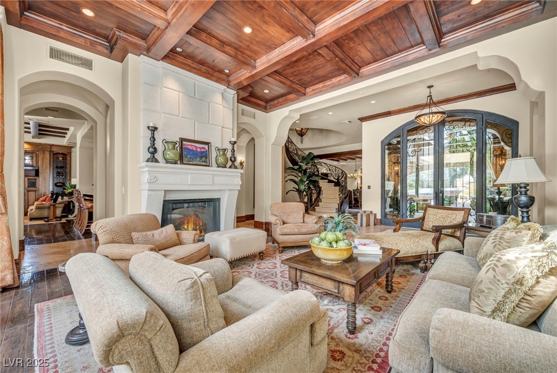 1793 Anelli Court Henderson, NV 89012 - Photo 22 of 47 Living area with arched walkways, french doors, a wood ceiling with exposed beams, coffered ceiling, and recessed lighting